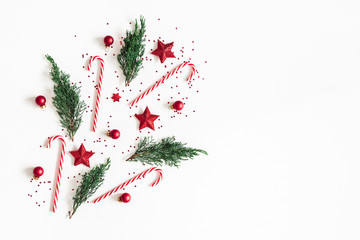 Christmas composition. Red decorations, fir tree branches on white background. Christmas, winter,...