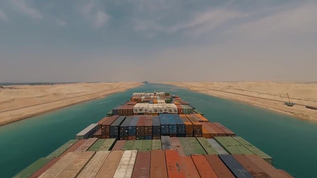 Suez, Egypt - huge container vessel proceeding through the Suez Canal. Time laps.