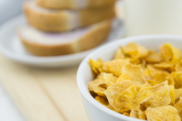 Golden Cornflakes (detailed close-up shot) on an old wooden table