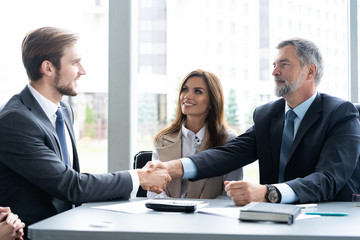 Business people shaking hands, finishing up a meeting. Handshake. Business concept.