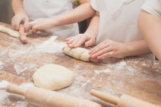 Young children make sausage dough. Hands closeup