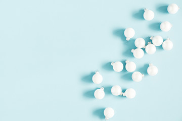 Christmas or winter composition. Pattern made of white balls on pastel blue background. Christmas, winter, new year concept. Flat lay, top view, copy space