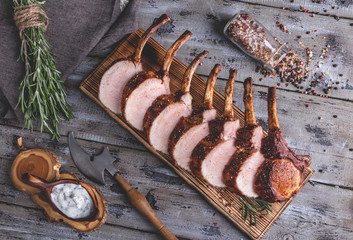 Grilled roasted rack of pork,slice meat chops on a portion wooden board