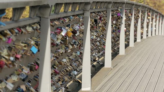 Padlocks of love on a bridge in Paris. Establishing shot