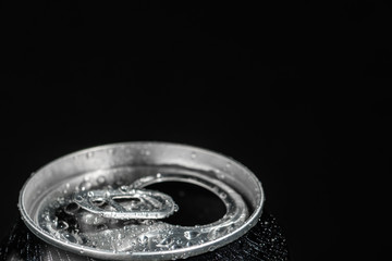 aluminum soda can neck with ring close-up covered with water drops