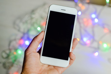 Ready for party time with mobile phone and electric led lights preparing busy holiday setting background.
