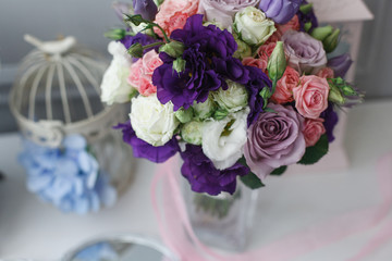Boutonniere and a bridal bouquet on a  white background.
wedding background
Bouquet of the bride in a glass vase
