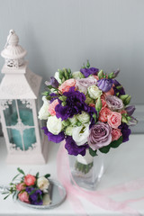 Boutonniere and a bridal bouquet on a  white background.
wedding background
Bouquet of the bride in a glass vase
