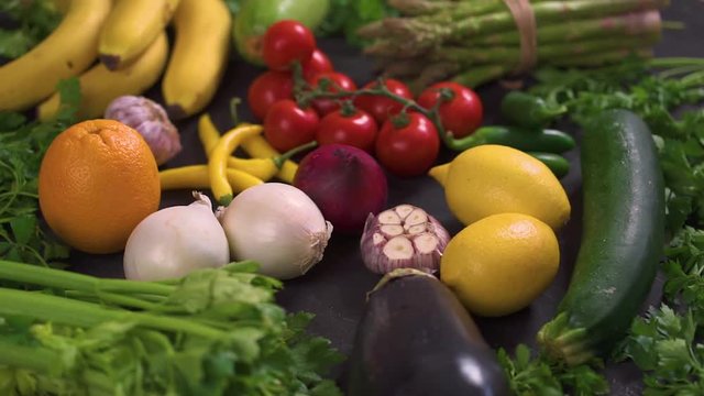 a large set of organic, colorful and fresh vegetables on a black wooden table