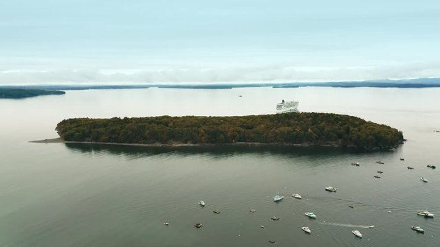 Aerial pull back drone shot above Bar Harbor, near Acadia National Park in Maine, on an overcast autumn day.