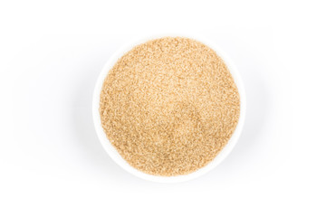 Demerara sugar in a white bowl. Top view