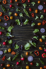 Clean eating concept. Frame of fresh organic vegetables on wooden table. Top view with copy space 