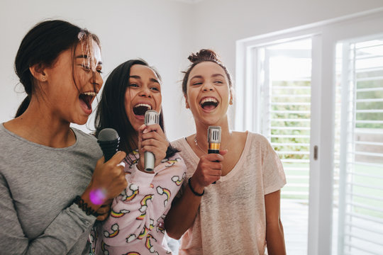 Girls singing karaoke at a sleepover - Powered by Adobe