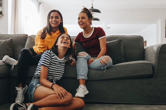 Girl Friends At Home Watching Television