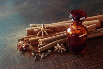 Obraz na płótnie Canvas Glass bottle of essential oil Cinnamon