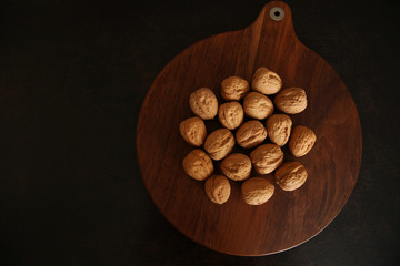 nuts in a shell on a brown wooden background. Healthy food. Flat lay. Top view.	