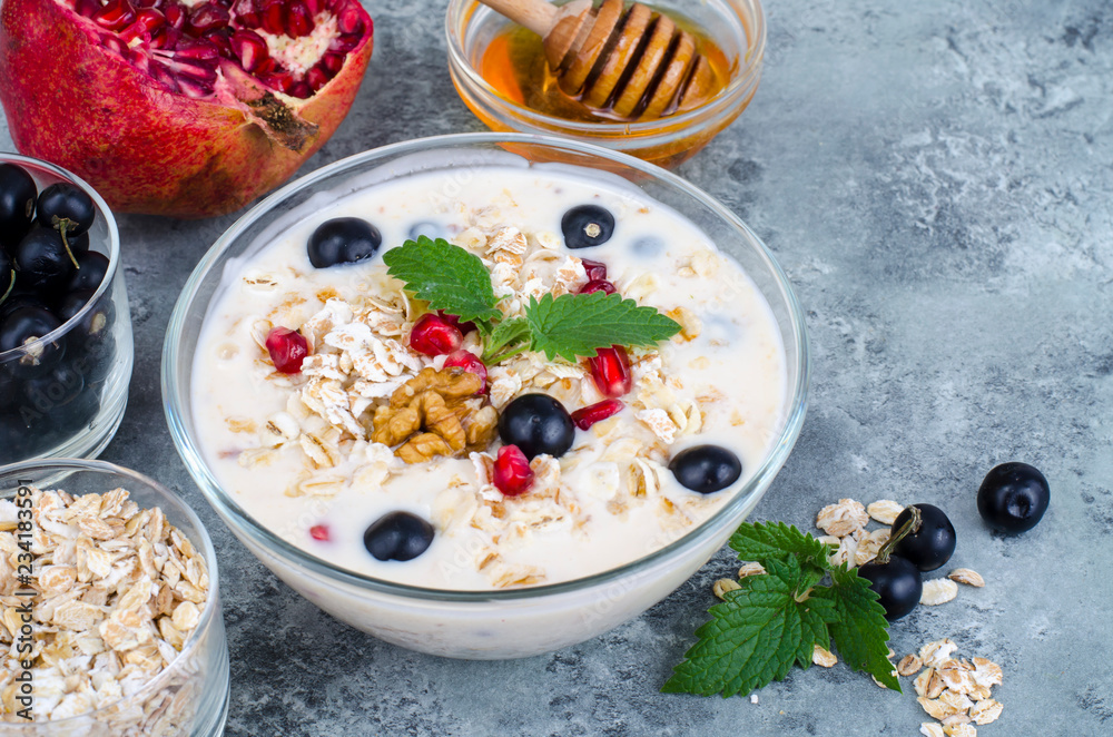 Wall mural healthy delicious muesli with oatmeal and pomegranat