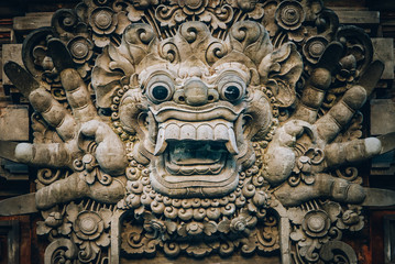 Closeup portrait of Hindu Buddhist traditional stone sculpture. Bali, Indonesia