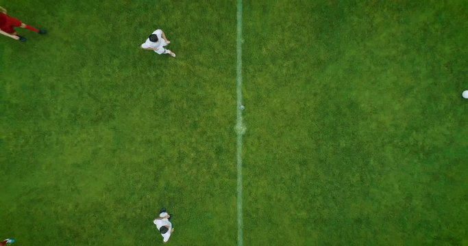 Aerial Top Down View of Soccer Field and Two Professional Teams Playing. Kick off Start of the Energetic Match on International Championship