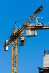 Construction cranes againsta a clear blue sky - photography