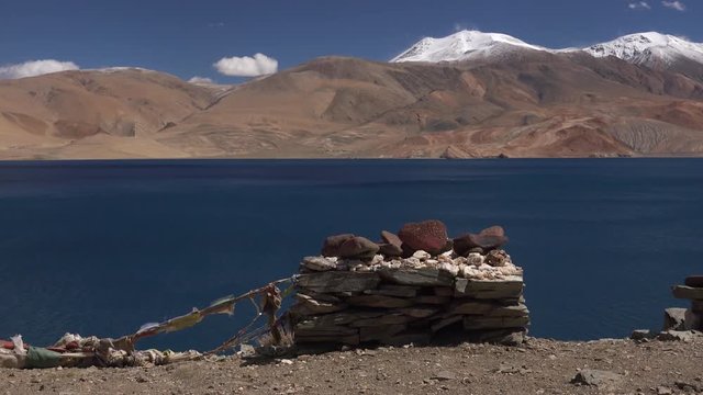 Spectacular view of traditional Buddhist stone pyramid decorated with carved mantras and praying flags. Meditation and zen at Tso Moriri lake among Himalaya mountains amazing nature. Ladakh, India