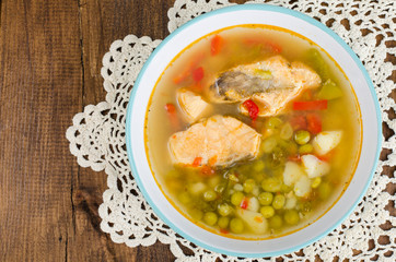 Bowl with salmon soup and fresh veggies