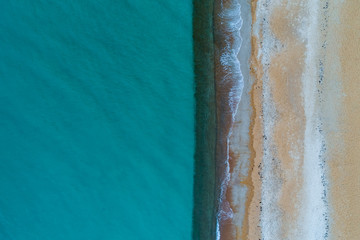 Minimalist aerial landscape - turquoise water and sandy beach with copy space