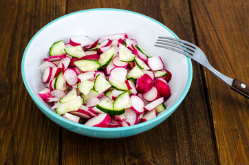 Bowl with sliced fresh radish and cucumber, vegetarian food