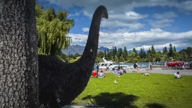 NEW ZEALAND, QUEENSTOWN - February 18, 2018: Timelapse video of park in the centre of Queenstown, New Zealand. Statue of extinct bird Moa in the foreground. Illustrative editorial footage.
