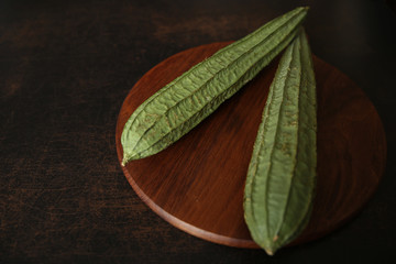 fresh okra on wooden background