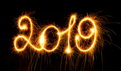 2019 with sparklers on black background