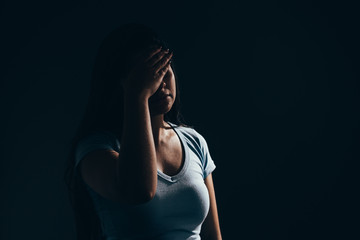 Sad woman in dark room. Depression and anxiety disorder concept