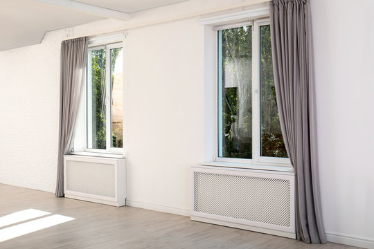 Modern windows with curtains in room. Home interior