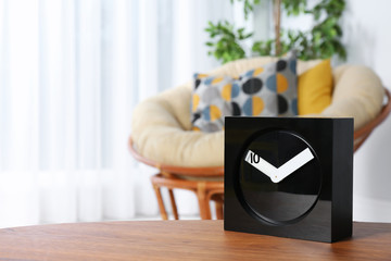 Analog clock on table indoors, space for text. Time management