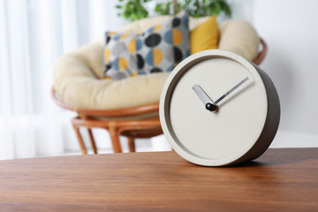 Analog clock on table indoors, space for text. Time management
