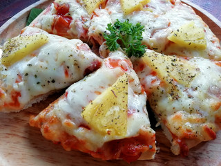 close up of Hawaiian pizza juicy pineapple chunks ham bits melted mozzarella cheese