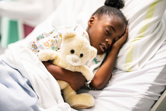 Little girl sleeping in a hospital bed