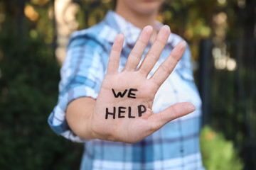 Woman showing hand with words 