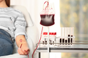 Woman making blood donation at hospital, closeup