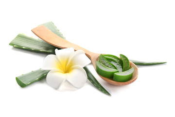 Wooden spoon with pieces of aloe vera and flower on white background