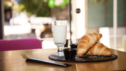 A couple of croissants and a glass of milk