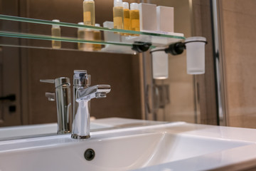 Chrome tap and white sink in bathroom