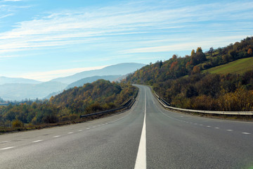 Obraz premium Landscape with asphalt road leading to mountains