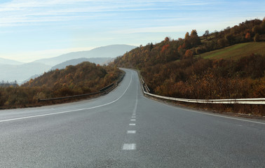 Fototapeta na wymiar Landscape with asphalt road leading to mountains