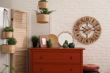 Stylish room interior with chest of drawers