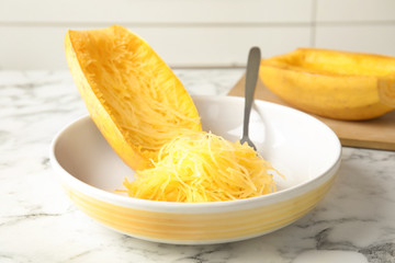 Cooked spaghetti squash and fork in dish on table