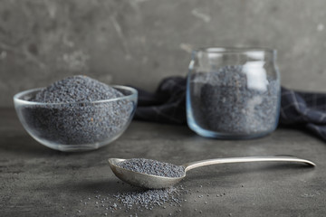 Poppy seeds in spoon and other dishware on table