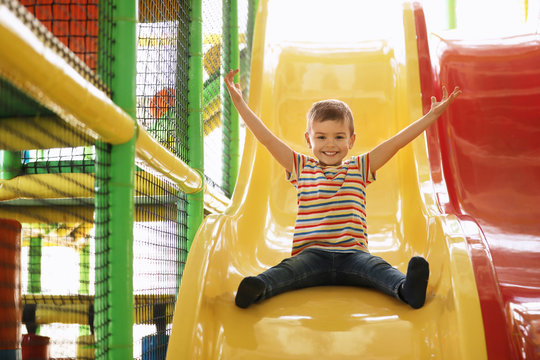 Cute Little Child Playing At Indoor Amusement Park