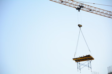 Yellow crane on the blue sky