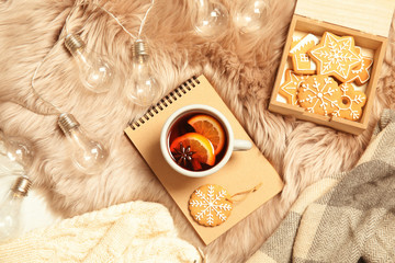 Flat lay composition with cup of hot winter drink on fluffy plaid. Cozy season